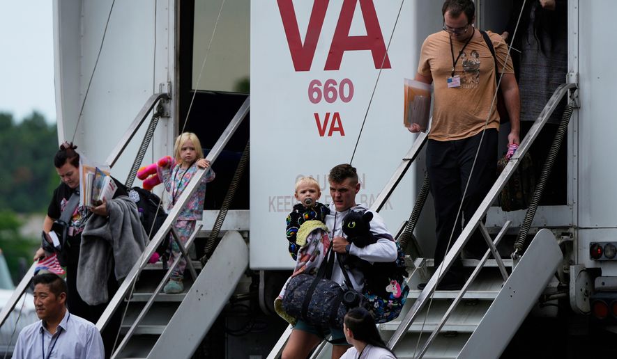 Refugees from South Africa, arrive Monday, May 12, 2025, at Dulles International Airport in Dulles, Va. (AP Photo/Julia Demaree Nikhinson, File)
