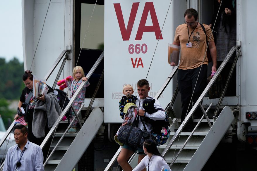 Refugees from South Africa, arrive Monday, May 12, 2025, at Dulles International Airport in Dulles, Va. (AP Photo/Julia Demaree Nikhinson, File)