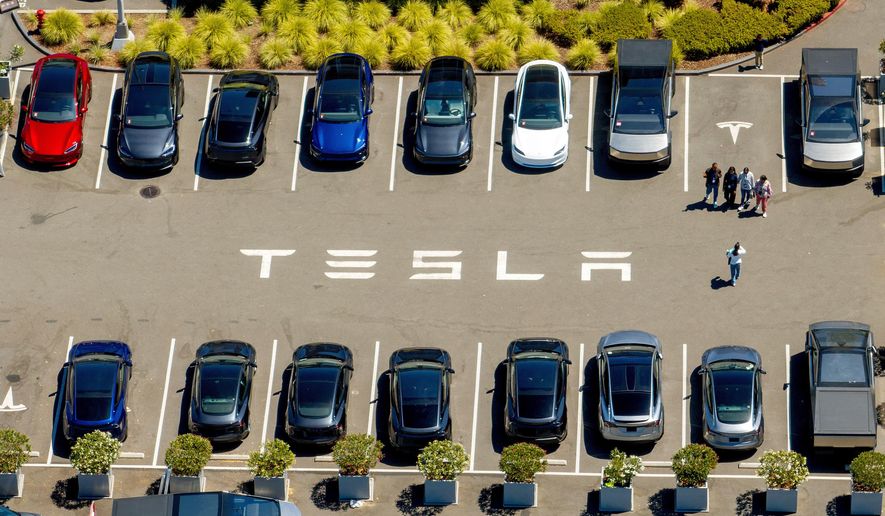 FILE - Tesla vehicles line a parking lot at the company's Fremont, Calif., factory on Aug. 5, 2025. (AP Photo/Noah Berger, File)