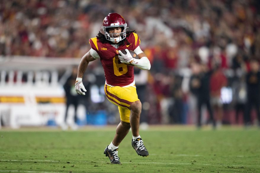 Southern California wide receiver Makai Lemon runs with the ball during the first half of an NCAA college football game against UCLA, Saturday, Nov. 29, 2025, in Los Angeles. (AP Photo/Kyusung Gong)