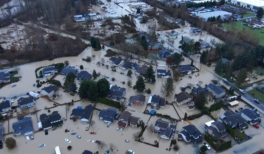 This image made from a video provided by the Pacific Police Department shows homes underwater, Tuesday, Dec. 16, 2025, in Pacific, Wash. (Pacific Police Department via AP)