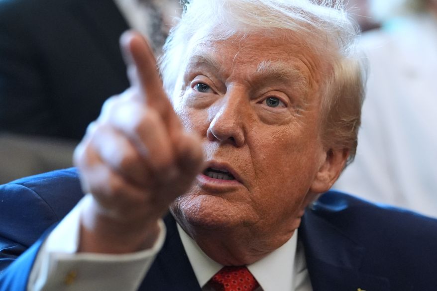 President Donald Trump points to a reporter for a question in the Oval Office of the White House, Thursday, Dec. 18, 2025, in Washington. (AP Photo/Evan Vucci)