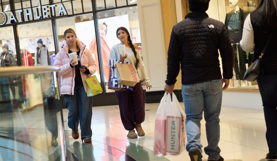 Shoppers walk around the Somerset Collection mall, Wednesday, Dec. 10, 2025, in Troy, Mich. (AP Photo/Ryan Sun)