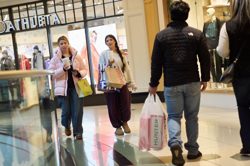 Shoppers walk around the Somerset Collection mall, Wednesday, Dec. 10, 2025, in Troy, Mich. (AP Photo/Ryan Sun)