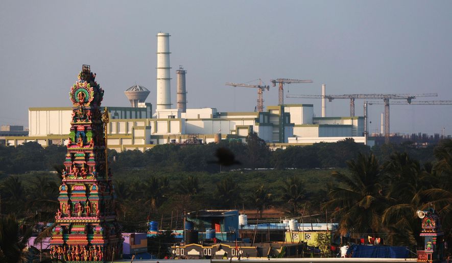 FILE - A temple stands in the foreground of the Madras Atomic Power Station located at Kalpakkam, in the Indian state of Tamil Nadu, Feb. 10, 2025. (AP Photo/R. Parthibhan, File)