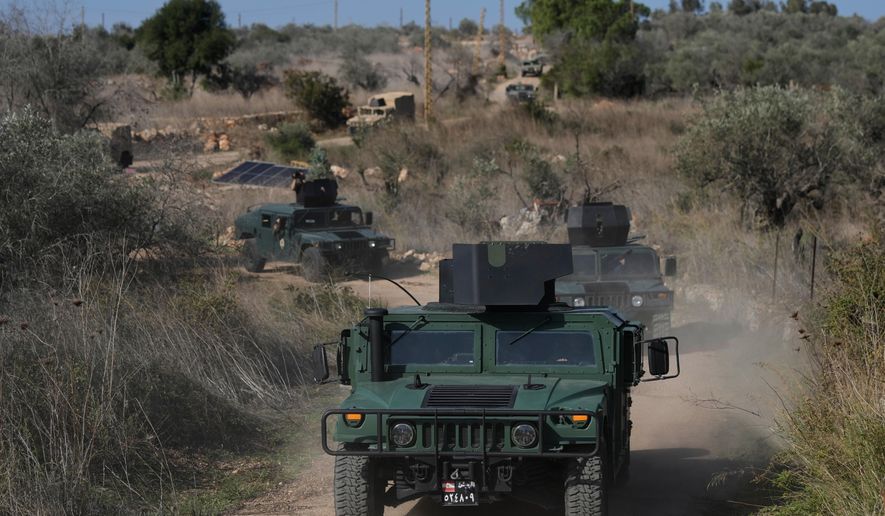 A convoy of Lebanese army vehicles drives near the border with Israel in the village of Alma al-Shaab during a Lebanese army media tour in south Lebanon, Friday, Nov. 28, 2025. (AP Photo/Bilal Hussein)