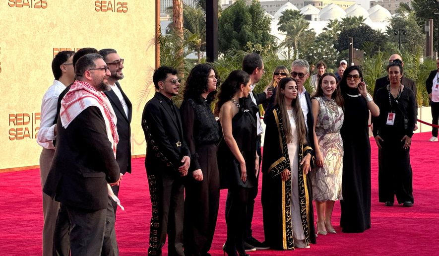 From left, Abdallah Sada, Alaa Alasad, Mohammad Siam, Israel Banuelos, Bassam Alasad, Mohammad Nizar, director Zain Duraie, Clara Khoury, George Christopoulos, Glenn Gainor, Ghalia Hatamleh and Lara Ab attend the screening of the film "Sink" during the Red Sea International Film Festival in Jeddah, Saudi Arabia, Monday, Dec. 8, 2025. (AP Photo/Baraa Anwer)