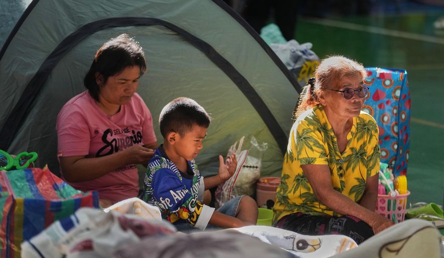 Thai residents who fled homes from fighting between Thailand and Cambodia along the border rest at an evacuation center in Surin province, Thailand, Tuesday, Dec. 16, 2025, (AP Photo/Sakchai Lalit)