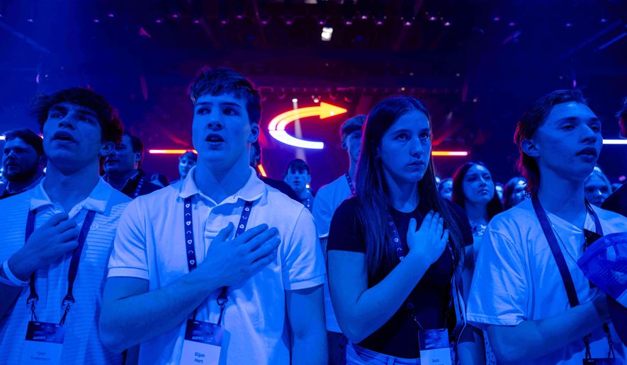Attendees stand during Turning Point USA's AmericaFest 2025, Thursday, Dec. 18, 2025, in Phoenix. (AP Photo/Jon Cherry)
