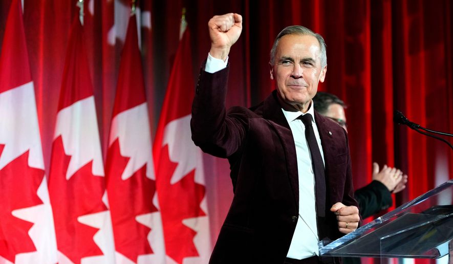 Canada's Prime Minister Mark Carney pumps his fist as he arrives to deliver remarks at the Liberal caucus holiday party in Ottawa, on Thursday, Dec. 11, 2025. (Justin Tang/The Canadian Press via AP, File)