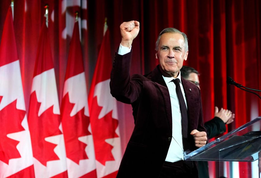 Canada's Prime Minister Mark Carney pumps his fist as he arrives to deliver remarks at the Liberal caucus holiday party in Ottawa, on Thursday, Dec. 11, 2025. (Justin Tang/The Canadian Press via AP, File)