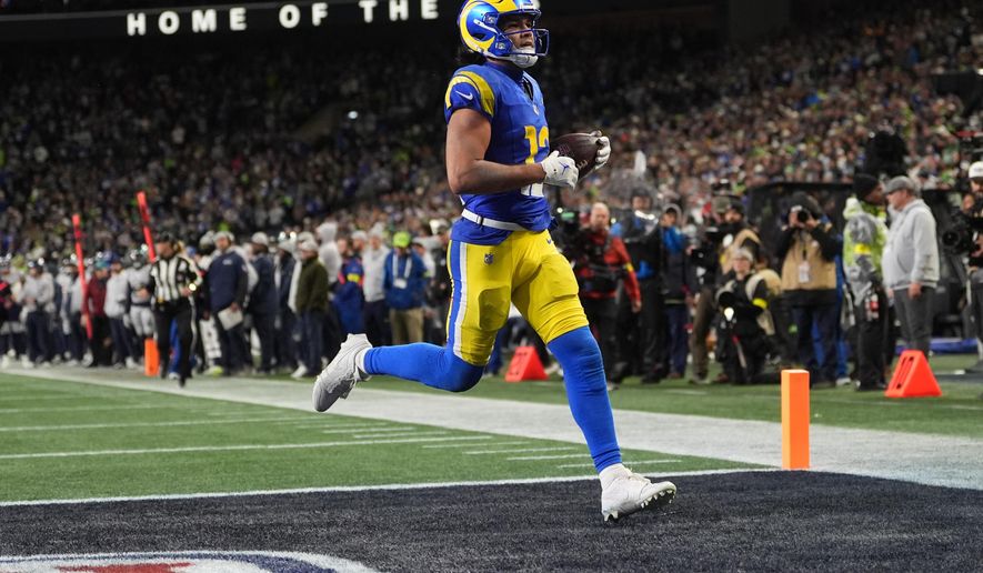 Los Angeles Rams wide receiver Puka Nacua scores a touchdown during overtime in an NFL football game against the Seattle Seahawks, Thursday, Dec. 18, 2025, in Seattle. (AP Photo/Lindsey Wasson)