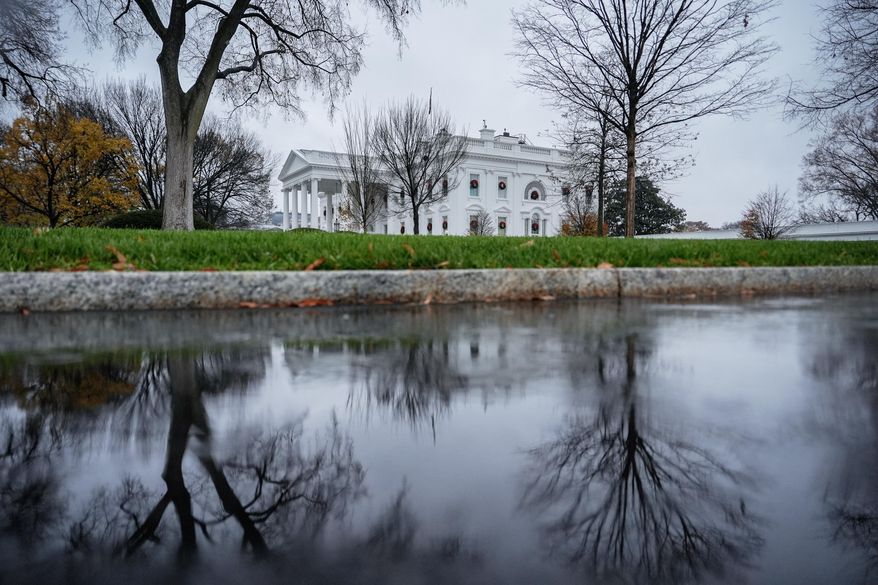 The White House is reflected in a puddle, Dec. 2, 2025, in Washington. (AP Photo/Julia Demaree Nikhinson, File)