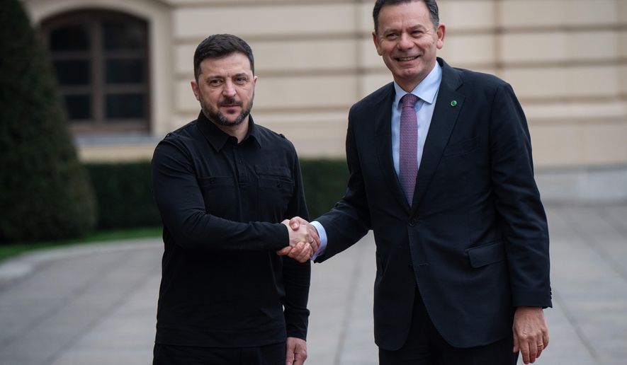 Ukraine's President Volodymyr Zelenskyy, left, shakes hands with Portuguese Prime Minister Luís Montenegro in Kyiv, Ukraine, Saturday, Dec. 20, 2025. (AP Photo/Danylo Antoniuk)