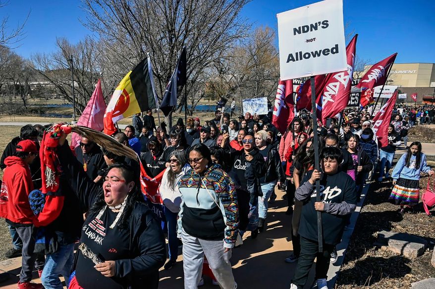 Demonstrators march from Memorial Park to the Andrew W. Bogue Federal building on Wednesday, March 23, 2022, in Rapid City, S.D., where it was announced that a federal civil rights lawsuit was filed against the Grand Gateway Hotel for denying services to Native Americans. (Matt Gade/Rapid City Journal via AP, File)