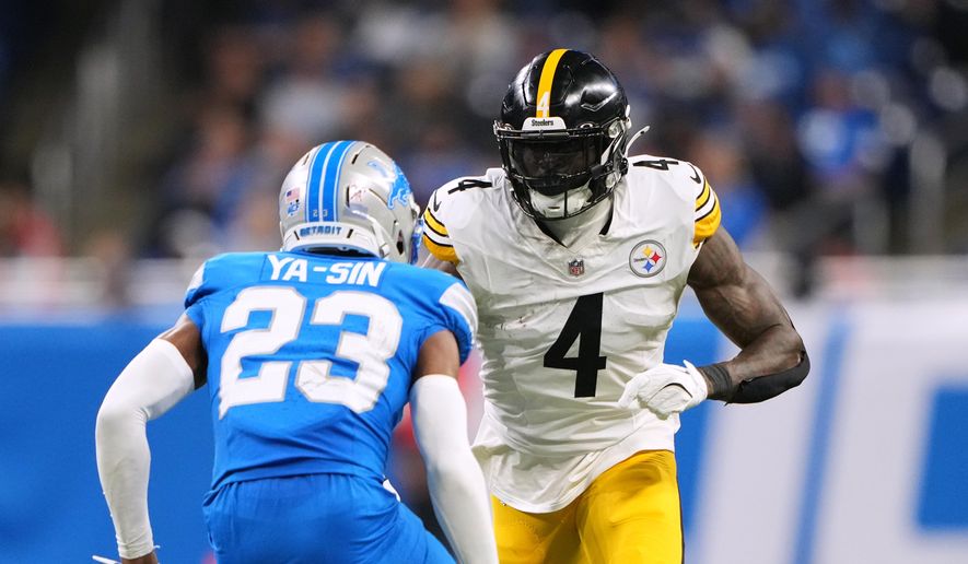 Pittsburgh Steelers' DK Metcalf, right, plays against Detroit Lions' Rock Ya-Sin during the second half of an NFL football game, Sunday, Dec. 21, 2025, in Detroit. (AP Photo/Ryan Sun)