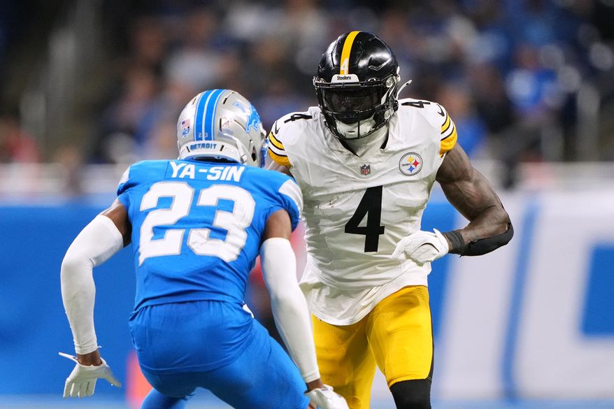 Pittsburgh Steelers' DK Metcalf, right, plays against Detroit Lions' Rock Ya-Sin during the second half of an NFL football game, Sunday, Dec. 21, 2025, in Detroit. (AP Photo/Ryan Sun)