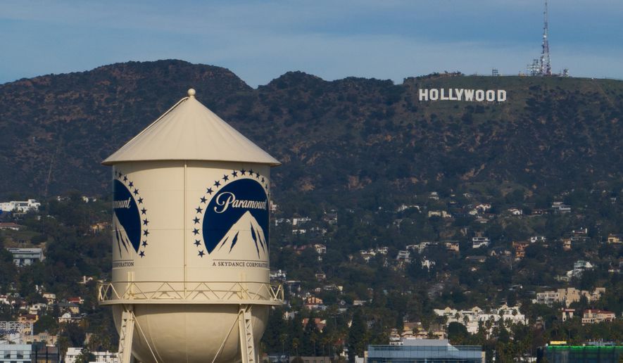 The Paramount Pictures water tower is seen in Los Angeles, Thursday, Dec. 18, 2025, with the Hollywood sign in the distance. (AP Photo/Jae C. Hong) ** FILE **