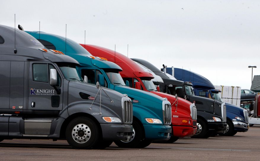 FILE - Big rigs stack up at the Flying J Truck Stop along Interstate 70 near the small Colorado plains community of Limon, May 21, 2009. (AP Photo/David Zalubowski, File)