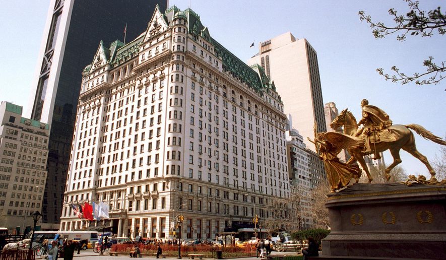 Pedestrians walk in front of the Plaza Hotel in New York on April 11, 1995. (AP Photo/Marty Lederhandler) **FILE**