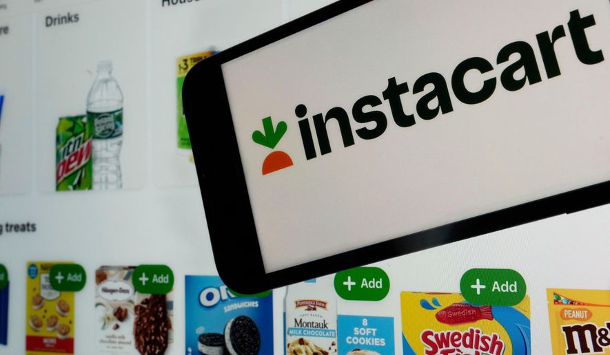 An Instacart logo and an Instacart webpage are seen in New York on Sept. 6, 2023. (AP Photo/Richard Drew) **FILE**