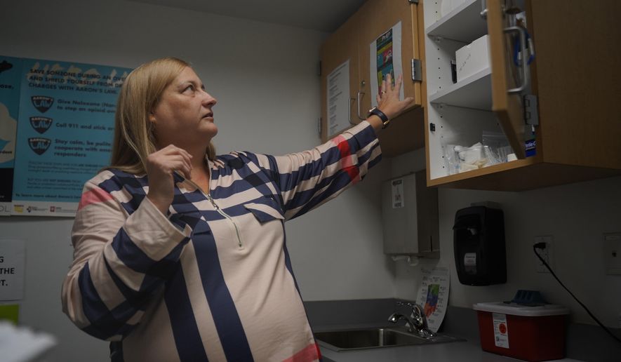 Dorothy Waterhouse, program director for the syringe exchange program at the Clark County Health Department, opens a cabinet containing supplies used for the program Tuesday, Nov. 23, 2025, in Jeffersonville, Ind. (AP Photo/Obed Lamy)
