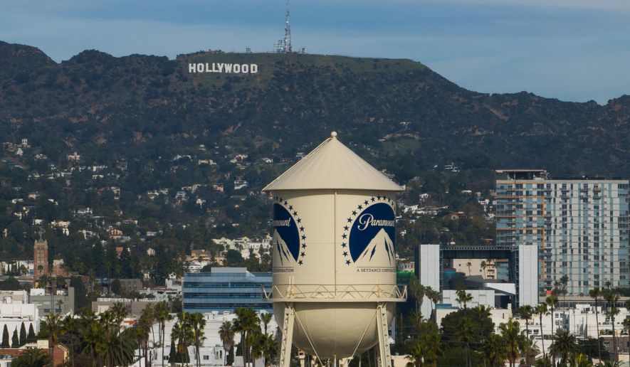 The Paramount Pictures water tower is seen in Los Angeles, Thursday, Dec. 18, 2025, with the Hollywood sign in the distance. (AP Photo/Jae C. Hong)