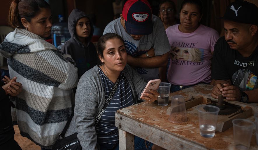 Relatives of Lt. Luis Enrique Castillo, a victim of a Mexican Navy plane crash off the Texas coast, learn about his death, at the family house in El Pantano, Veracruz state, Mexico, Tuesday, Dec. 23, 2025. (AP Photo/Felix Marquez)