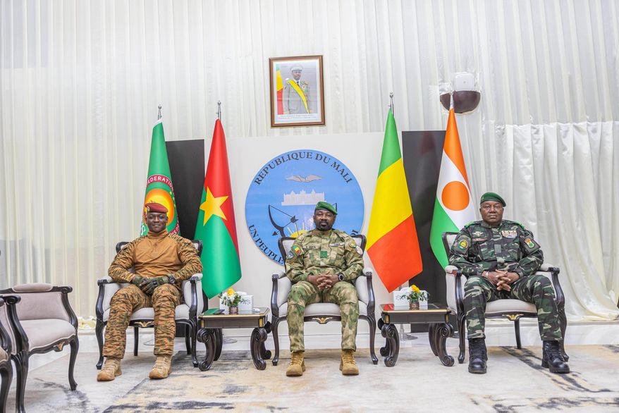 Captain Ibrahim Traoré of Burkina Faso, left, General Assimi Goïta of Mali, center, and General Abdourahamane Tchiani of Niger attend the second summit on security and development in Bamako, Mali, Tuesday, Dec. 23, 2025. (Mali Government Information Center via AP)