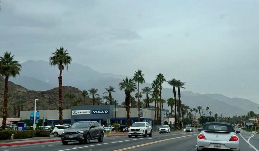 Drivers make their way in the rain on East Palm Canyon Drive, Tuesday, Dec. 23, 2025, in Palm Springs, Calif. (AP Photo/Pamela Hassell)