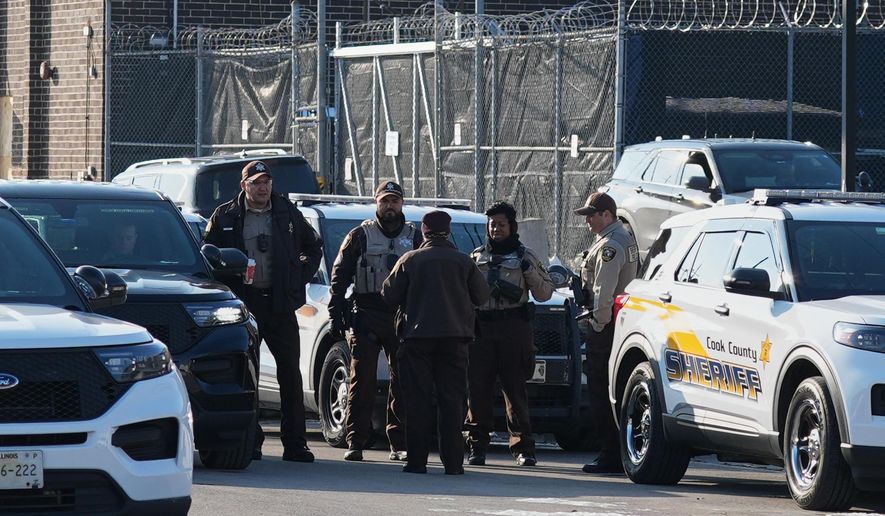 Law enforcement officers guard as protesters gather outside an ICE processing facility in the Chicago suburb of Broadview, Ill., Friday, Dec. 12, 2025. (AP Photo/Nam Y. Huh)