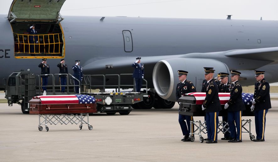 The remains of Staff Sgt. Edgar Brian Torres-Tovar, 25, of Des Moines, and Staff Sgt. William Nathaniel Howard, 29, of Marshalltown, the two Iowa National Guard members killed in an attack in the Syrian desert, are moved during a dignified transfer at the Des Moines International Airport in Des Moines, Iowa, Wednesday, Dec. 24, 2025. (AP Photo/Charlie Neibergall)