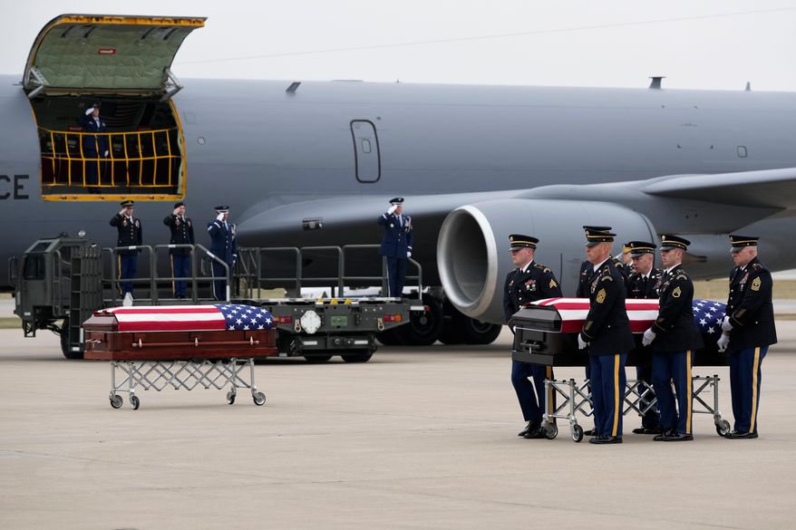 The remains of Staff Sgt. Edgar Brian Torres-Tovar, 25, of Des Moines, and Staff Sgt. William Nathaniel Howard, 29, of Marshalltown, the two Iowa National Guard members killed in an attack in the Syrian desert, are moved during a dignified transfer at the Des Moines International Airport in Des Moines, Iowa, Wednesday, Dec. 24, 2025. (AP Photo/Charlie Neibergall)