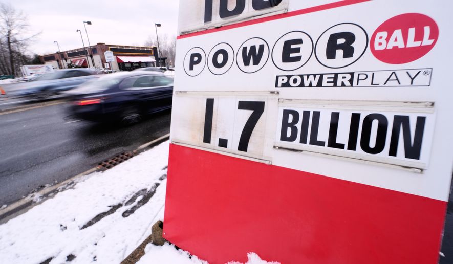 The jackpot for the Powerball lottery game is displayed outside Ted's State Line Mobil station, Wednesday, Dec. 24, 2025, in Methuen, Mass. (AP Photo/Charles Krupa)