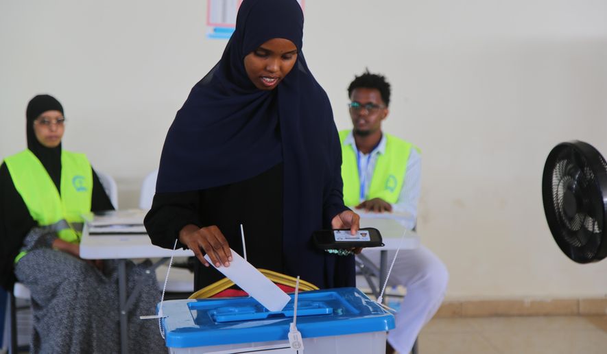 A woman casts her vote during the local election in Mogadishu, Somalia, Thursday, Dec. 25, 2025. (AP Photo/Farah Abdi Warsameh)