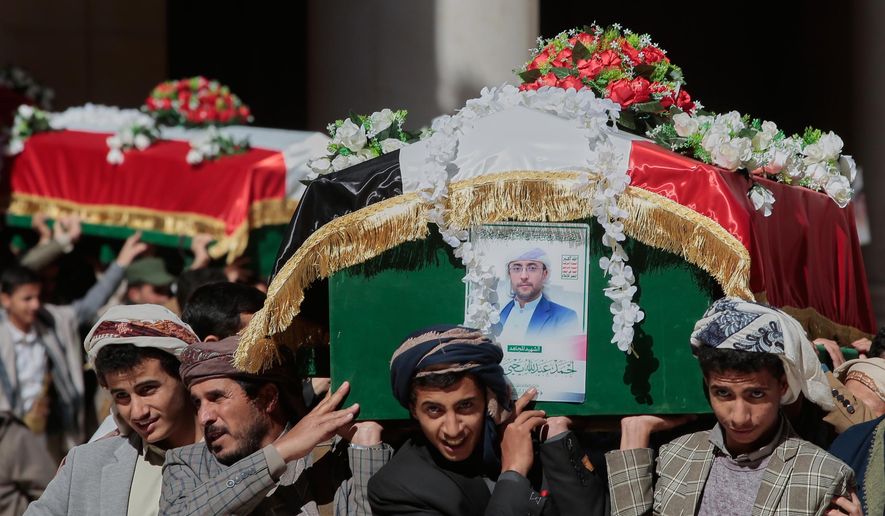 Houthi supporters carry the coffins of 5 leaders, who they said were killed during previous Israeli airstrikes, during a funeral at the people's mosque in Sanaa, Yemen, Thursday, Dec. 25, 2025. (AP Photo/Osamah Abdulrahman)