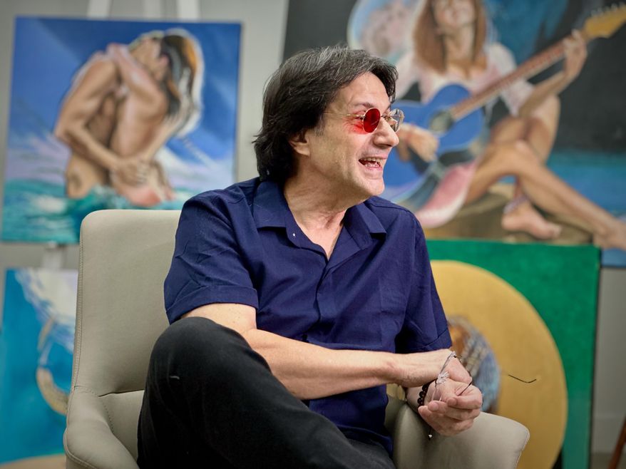 Fernando Dávila, a colorblind painter, speaks during an interview with The Associated Press at his gallery in Doral, Fla. on Thursday, Dec. 18, 2025. (AP Photo/Cody Jackson)