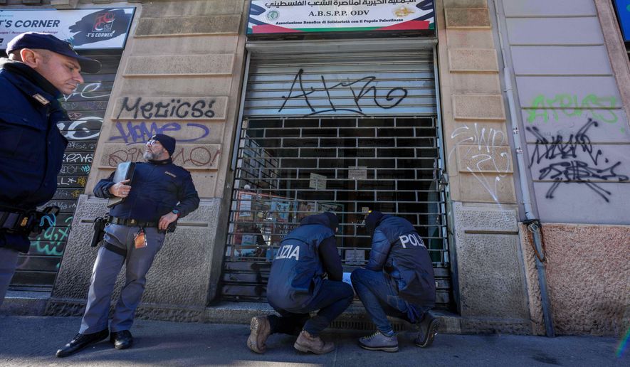 Police officers inspect a charitable association supporting Palestinian civilians in Milan, Italy, Saturday, Dec. 27, 2025 after Italian investigators have arrested nine people suspected of raising millions of euros for Hamas. (Claudio Furlan/LaPresse via AP)
