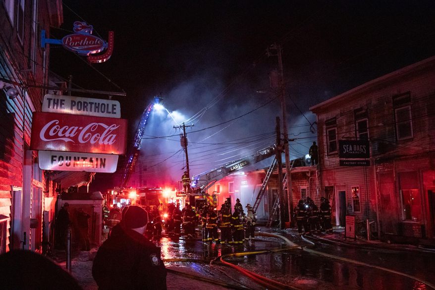 Firefighters battle a three-alarm fire on the historic Old Port waterfront late Friday, Dec. 27, 2025 in Portland, Maine. (Libby Kamrowski Kenny/Portland Press Herald via AP)