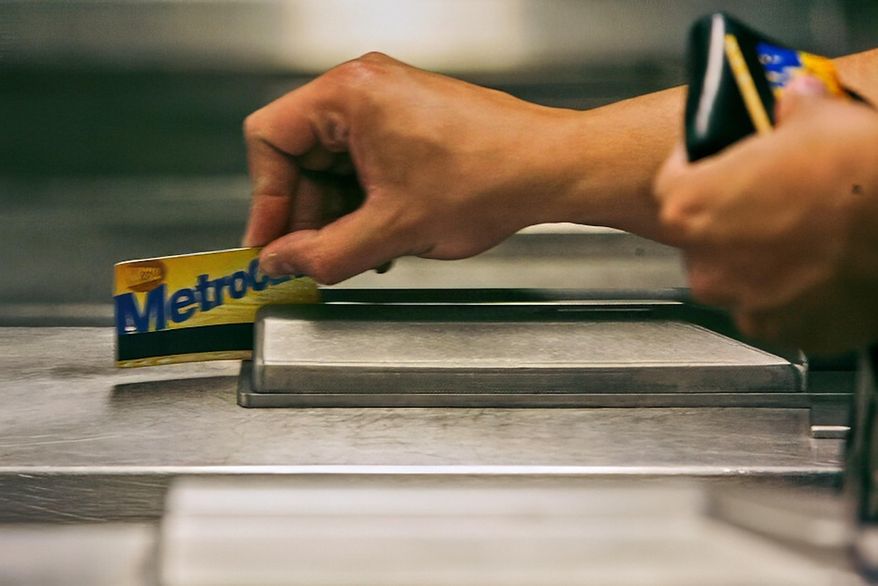 FILE - A subway rider swipes his MetroCard in a turnstile as he enters the 34th St. subway station, July 23, 2007, in New York. (AP Photo/Mary Altaffer, File)