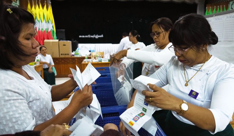 Officials of the Union Election Commission prepare to count votes at a polling station, during the first phase of general election, in Naypyitaw, Myanmar, Sunday, Dec. 28, 2025. (AP Photo/Aung Shine Oo)