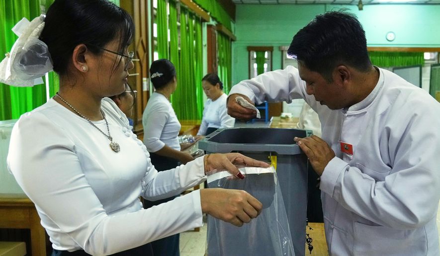Official of the Union Election Commission prepare to close a polling station after the votes are counted, during the first phase of general election, in Naypyitaw, Myanmar, Sunday, Dec. 28, 2025. (AP Photo/Aung Shine Oo)