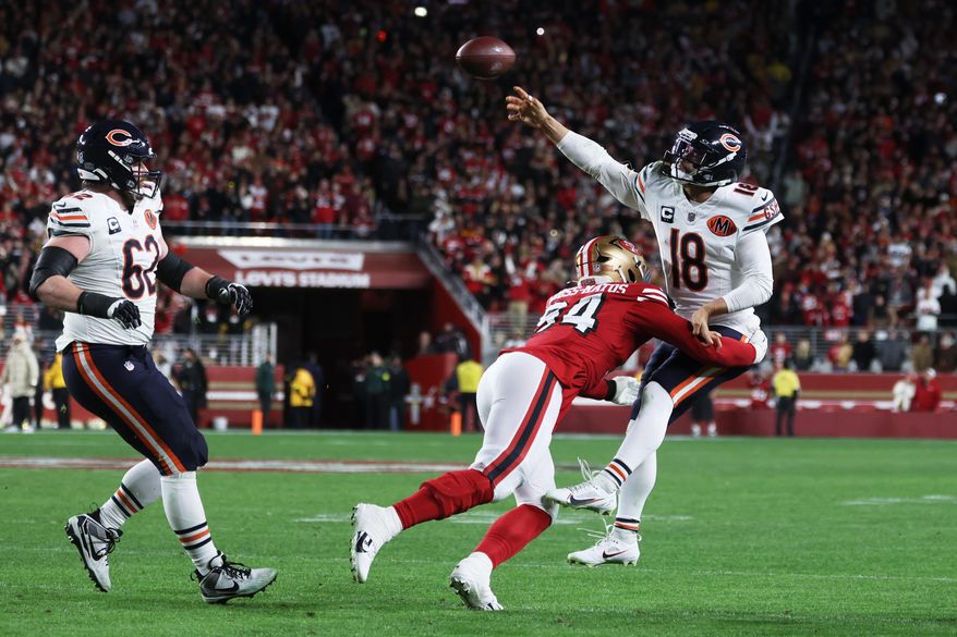 Chicago Bears quarterback Caleb Williams (18) passes while pressured by San Francisco 49ers defensive end Yetur Gross-Matos (94) on the final play of the second half of an NFL football game in Santa Clara, Calif., Sunday, Dec. 28, 2025. (AP Photo/Jed Jacobsohn)