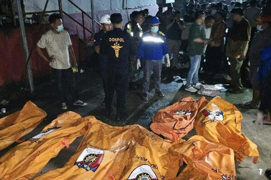 In this photo released by North Sulawesi Regional Police on Monday, Dec. 29, 2025, body bags containing victims of a fire at a nursing home in Manado, North Sulawesi province, Indonesia. (North Sulawesi Regional Police via AP)