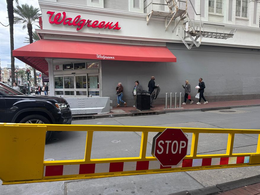 An opened gate is seen at the Bourbon Street corner in New Orleans on Monday, Dec. 29, 2025, the site of a Jan. 1, 2025, fatal vehicle ramming attack which led the city to bolster its safety measures in the area. (AP Photo/Jack Brook)