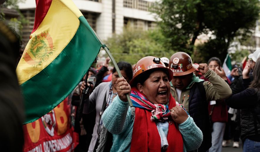 Miners march to protest President Rodrigo Paz's decision to remove fuel subsidies in La Paz, Bolivia, Monday, Dec. 29, 2025. (AP Photo/Freddy Barragan)
