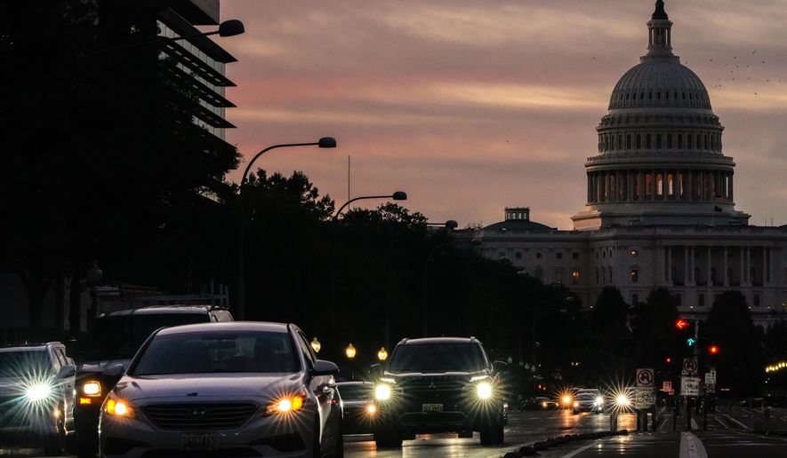 Vehicles drive along Pennsylvania Avenue during rush hour traffic at sunrise in Washington, with the U.S. Capitol in the background, on Wednesday, Oct. 1, 2025. (AP Photo/Julia Demaree Nikhinson) **FILE**