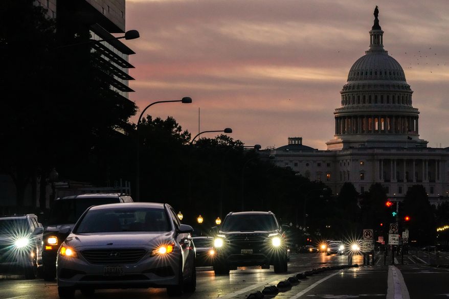 Vehicles drive along Pennsylvania Avenue during rush hour traffic at sunrise in Washington, with the U.S. Capitol in the background, on Wednesday, Oct. 1, 2025. (AP Photo/Julia Demaree Nikhinson) **FILE**