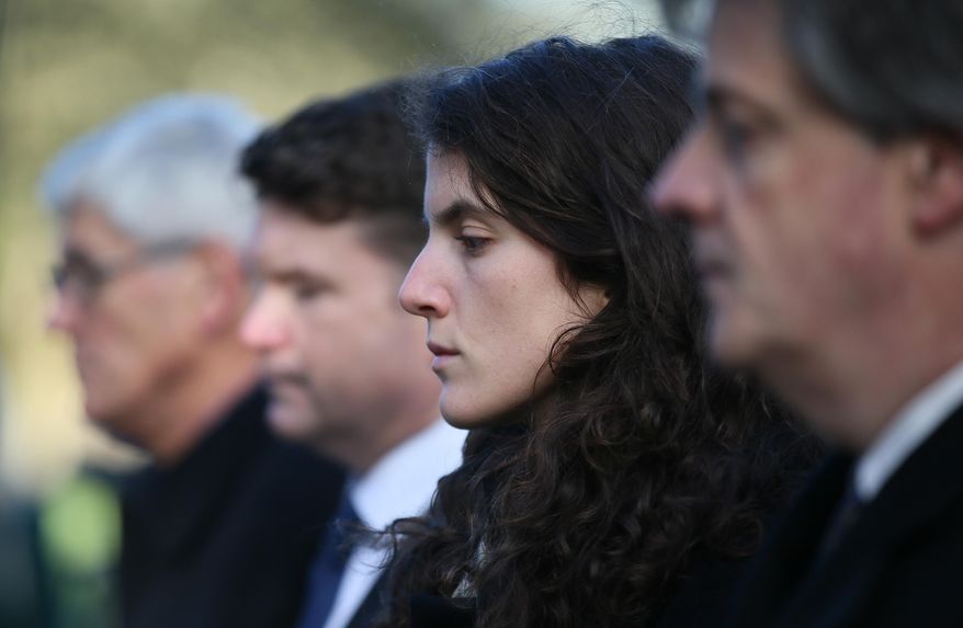 Tatiana Schlossberg, second right, granddaughter of President J.F. Kennedy pauses for a moment of silence during a short ceremony at the JFK memorial Runnymede, England, Friday, Nov. 22, 2013. (AP Photo/Alastair Grant, File)