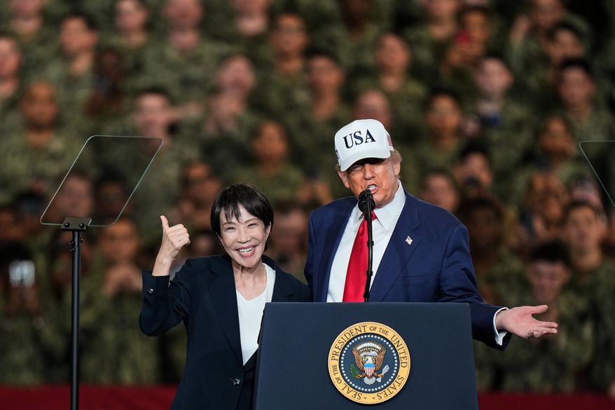Japanese Prime Minister Sanae Takaichi gestures as U.S. President Donald Trump delivers his speech during their visit to the aircraft carrier USS George Washington at the U.S. Navy's Yokosuka base in Yokosuka, south of Tokyo, Tuesday, Oct. 28, 2025. (AP Photo/Eugene Hoshiko, File)